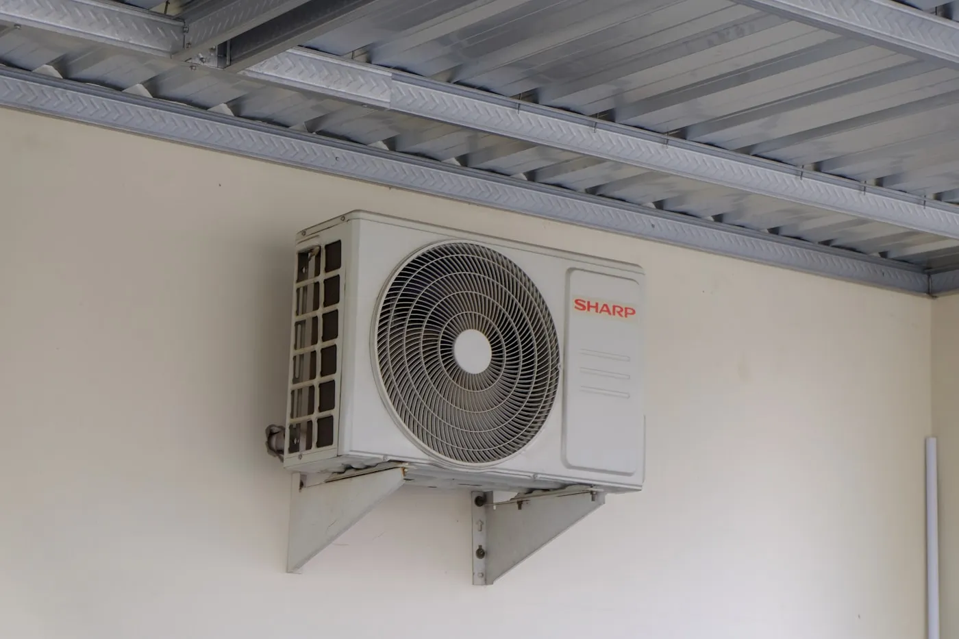 Compact ductless indoor unit above a bonus room doorway