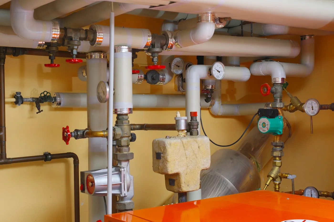 High-efficiency boiler with insulated piping and gauges in a mechanical room